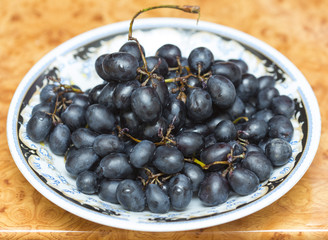black grapes on a plate