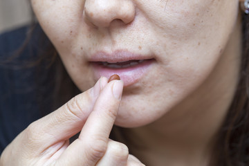 woman drinks pills
