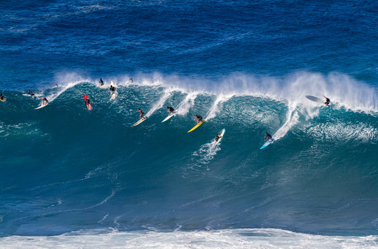 Surfers riding a wave in Hawaii