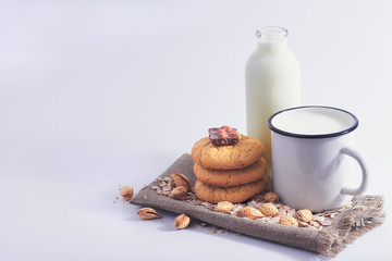 Still life of milk, nuts, biscuits and chocolate.