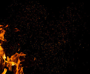 Flame of fire with sparks on a black background