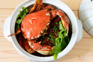 mud crab with glass noodles cooked and served in a clay pot