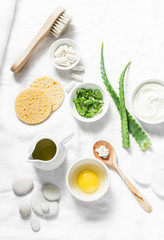Aloe face mask ingredients -aloe, yogurt, egg, olive oil and beauty accessories on light background, top view. Home recipe. Flat lay