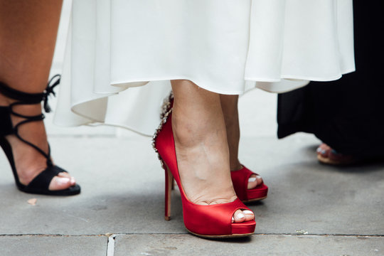 A bride's red high-heeled shoes during an urban city wedding