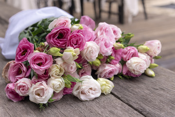 Beautiful bouquet of pink roses on wood background, outdoor
