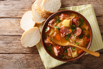 Czech recipe: Sauerkraut Soup (Zelnacka) close-up in a bowl. Horizontal top view