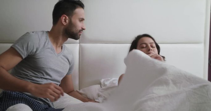 Man Trying Sexual Approach With Woman In Bed At Home