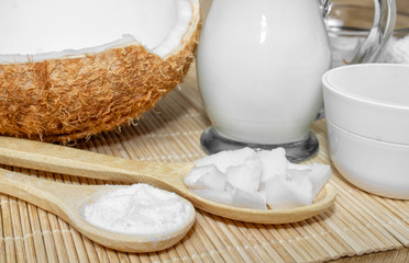 Coconut in cosmetology. Сream, balm, coconut milk. Skin, body and face care. Cosmetology. Nutrition and hydration. Homemade coconut products. Wooden spoons with coconut pulp and in powder.