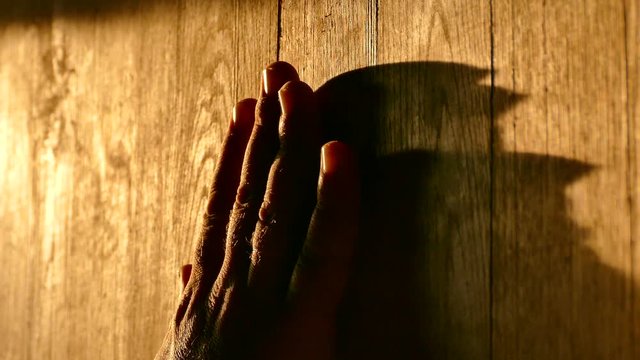 The master spends his hand on processed wooden boards. An ancient wooden surface. Texture