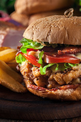 Chickenburger with bacon, tomato, cheese and lettuce