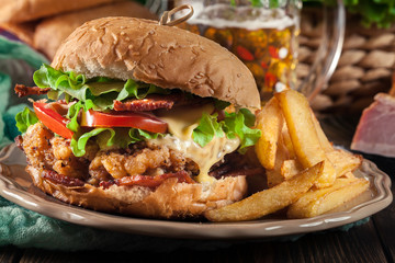 Chickenburger with bacon, tomato, cheese and lettuce