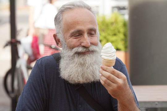 Happy Senior Man Eating Ice Cream Cone