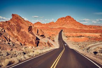 Retro stylized picture of a scenic desert road, travel concept.