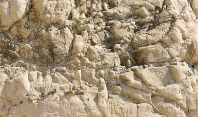 Rough rock surface texture with brown rocks 