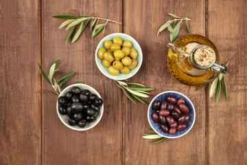 Overhead photo of various olives and olive oil with copy space