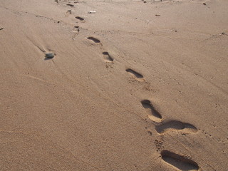 Footsteps texture on sandy beach