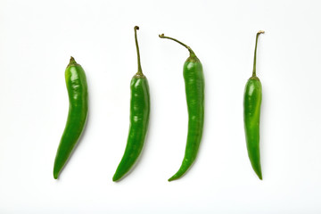 Green chili pepper on a white background. Green chili pepper of different shapes isolated on white background