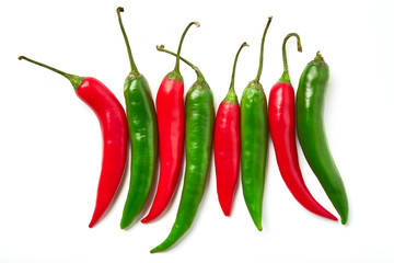 Red and green chili pepper on a white background. Red and green chili pepper of different shapes isolated on white background