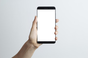 Close-up in the hand of a smartphone with a white screen on a white background.