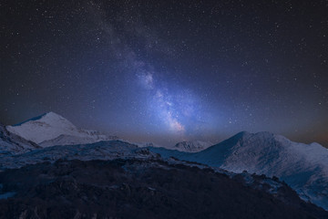 Fototapeta na wymiar Vibrant Milky Way composite image over landscape of Mount Snowdon and other peaks in Snowdonia National Park