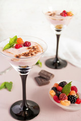 Milk dessert with berries in tall glasses. Selective focus.