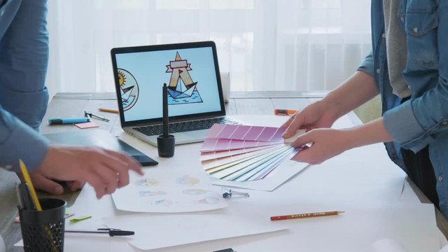 Graphic designers choosing a color for logo design