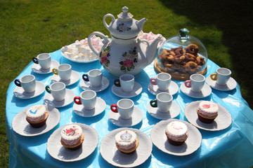 A festive table for children with cakes and sweets for tea and coffee. Table with cakes and sweets for tea.