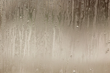 Wetted glass on the window as a background