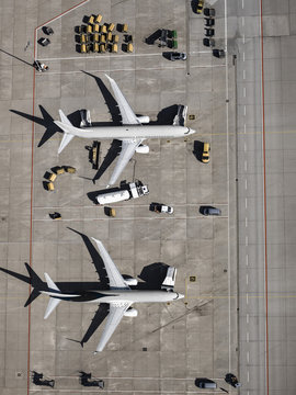 Aerial view commercial airplanes being serviced on tarmac at airport