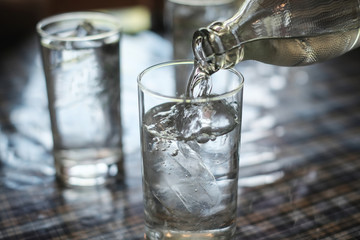 Pour water into the glass