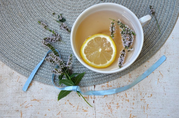  herbal tea with lemon and mint in a white mug