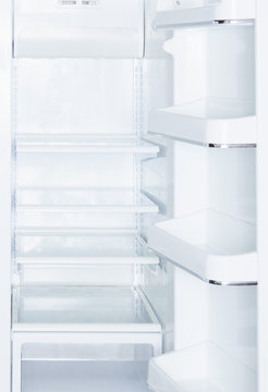 Empty, open white refrigerator