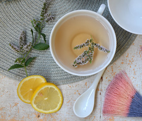  herbal tea with lemon and mint in a white mug