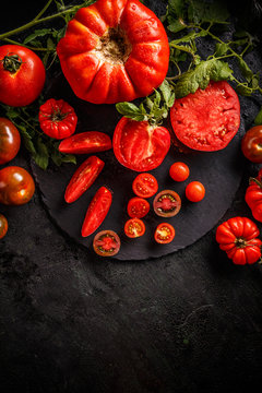 Cutting red tomatoes composition