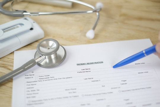 Personal perspective patient filling out medical patient registration form