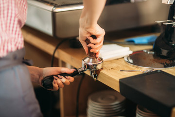 Barista using a coffee machine in cafe