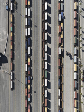Aerial view trains in sunny shunting yard, Los Angeles, California, USA