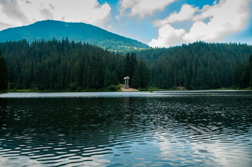 Fototapeta na wymiar Lake in the forest in the mountains