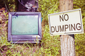 Old television CRT (Cathode ray tube) abandoned in nature with 