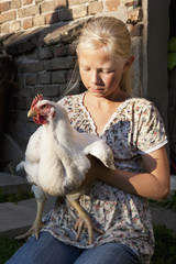 Girl holding rooster