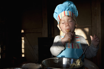 Girl in chefs hat baking