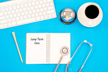 Stethoscope on notebook and pencil with Long Term Care words as medical concept