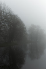 Fototapeta na wymiar Ominous And Foggy Water Landscape