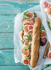Sandwich prosciutto mascarpone cheese figs wooden table copy space top view