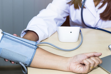 Hand woman professional doctor check blood pressure with patient at hospital.Copy space.