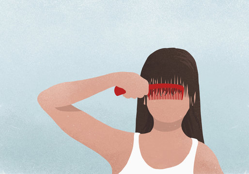 Brunette woman combing bangs