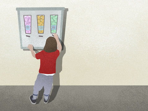 Boy standing at candy vending machine