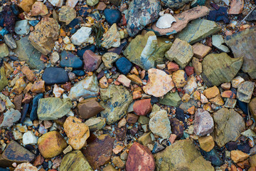Colorful sea pebbles. rough sea stones, gravel texture of nature background and wallpaper. can be use for nature wallpaper,background, greeting card, advertizing, backdrop and board