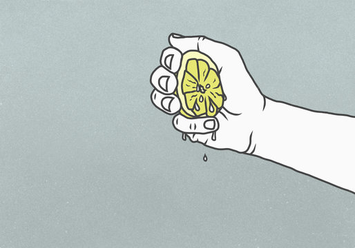 Man squeezing juicy lemon