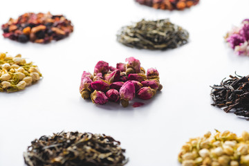 set of dried herbal natural tea on white surface